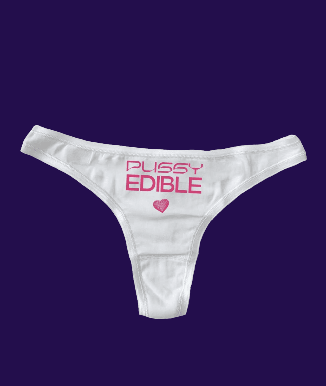 White thong with pink text "Pussy Edible" and a small heart, set against a solid dark background.